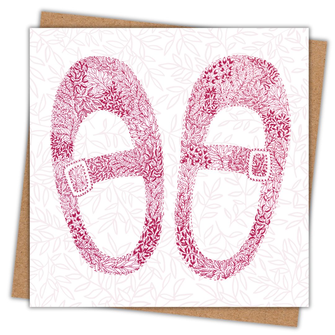 Illustrated baby girl shoes made from intricate floral line art on pale leafy background with kraft envelope beneath