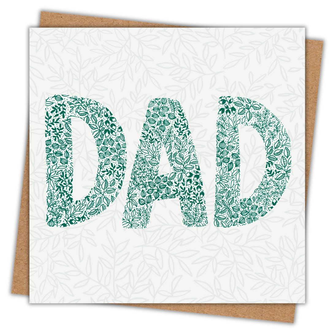 Greeting card for Dads with the word Dad written on the front of it. The lettering is made out of rich green leaves and botanical elements. Behind them is a soft leafy pattern. Behind the card is a brown recycled Kraft envelope.
