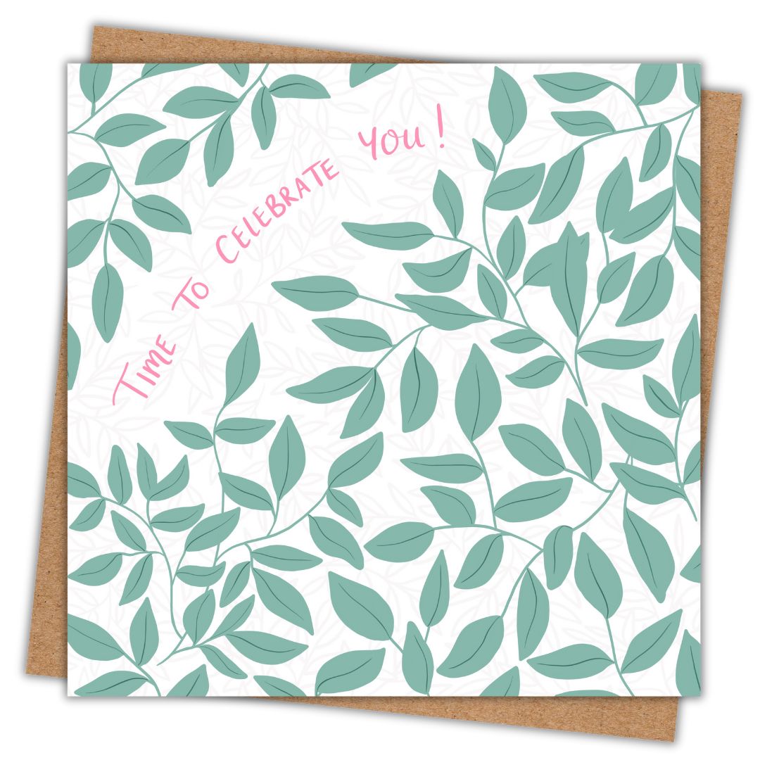 Irish leafy greeting card with the words Time To Celebrate You! written in a floral pink tone. The rest of the card is covered in green leaves. The card is sitting on a recycled brown Kraft envelope.
