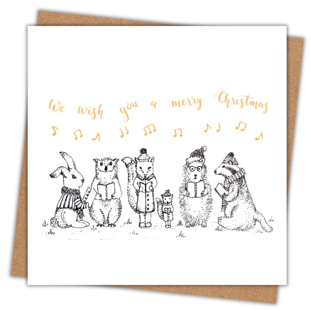 Christmas card with a group of woodland animals carol singing. Above them are a scattering of music notes in gold writing, along with the phrase "We wish you a merry christmas"