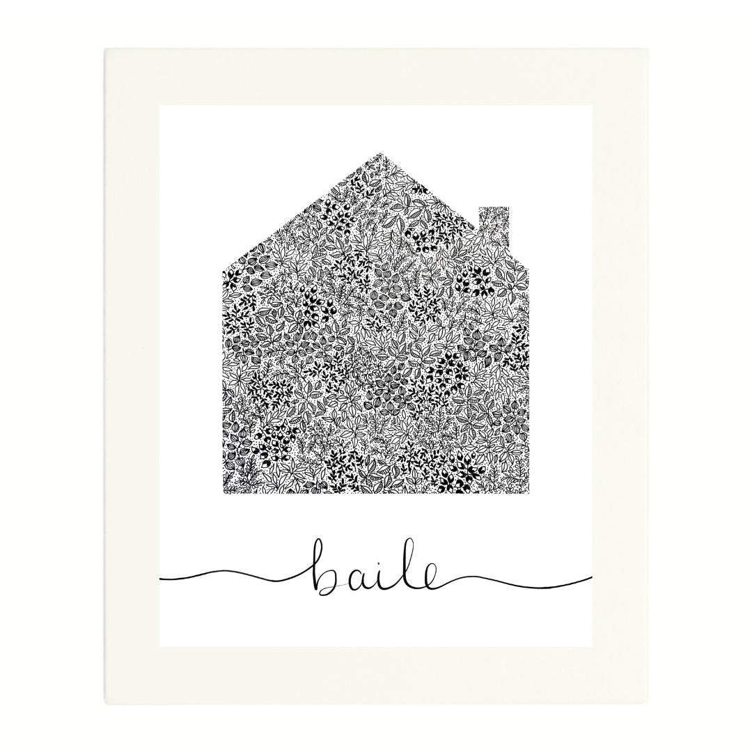Irish language art print in a white mount. The black and white design is created from a pen illustration of a house. Small intricate leaves and dots make up the shape of the house with a small chimney on one side. Below the black pen house is the Irish title "Baile" in a flowing script. The background of the design is white.