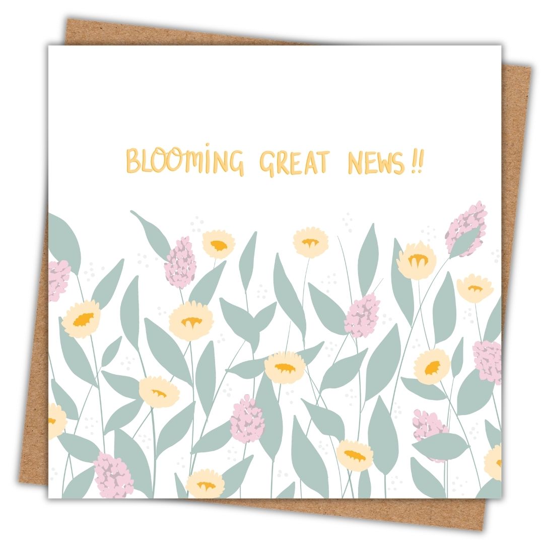 A cheerful pretty botanical greeting card, with the botanical themed phrase "Blooming great news!!" hand-written in gold in the top part of the card. Underneath "Blooming great news" are large sage green leaves, big yellow flower heads similar to sunflowers, and large pinky purple flower heads, like wisteria or Buddleia. The card has a white background. There's a brown kraft envelope beneath the card.