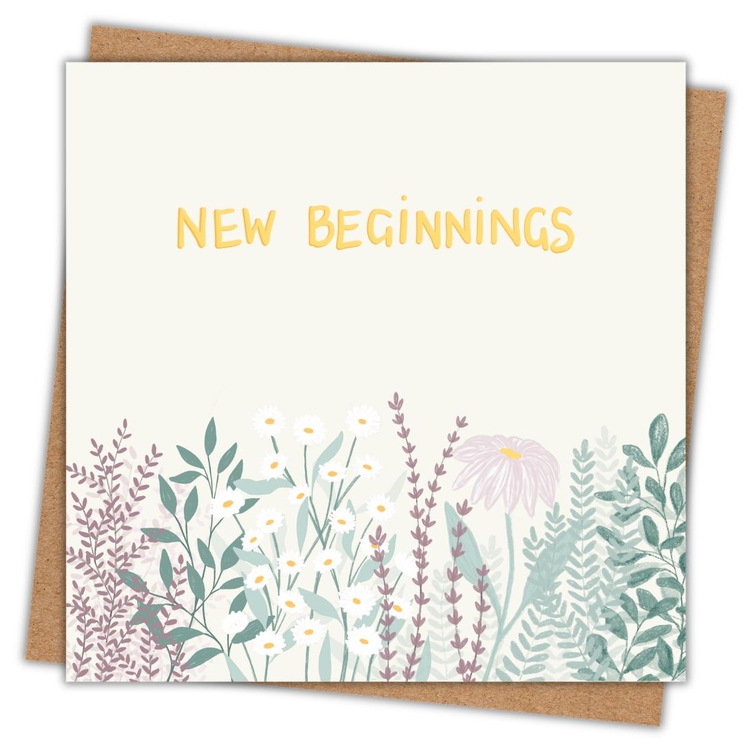 This botanical greeting card has the words "New Beginnings" hand written in gold in the top part of the card. Below it there are clusters of leaves in various shades of green as well as wild flowers, and daisies. The background of the card is a very very faint lemon colour. The flowers and leaves underneath are like a wildflower patch and use natural greens, lavender pinks and purples and some yellows and golds too. The card has a kraft brown envelope beneath it.