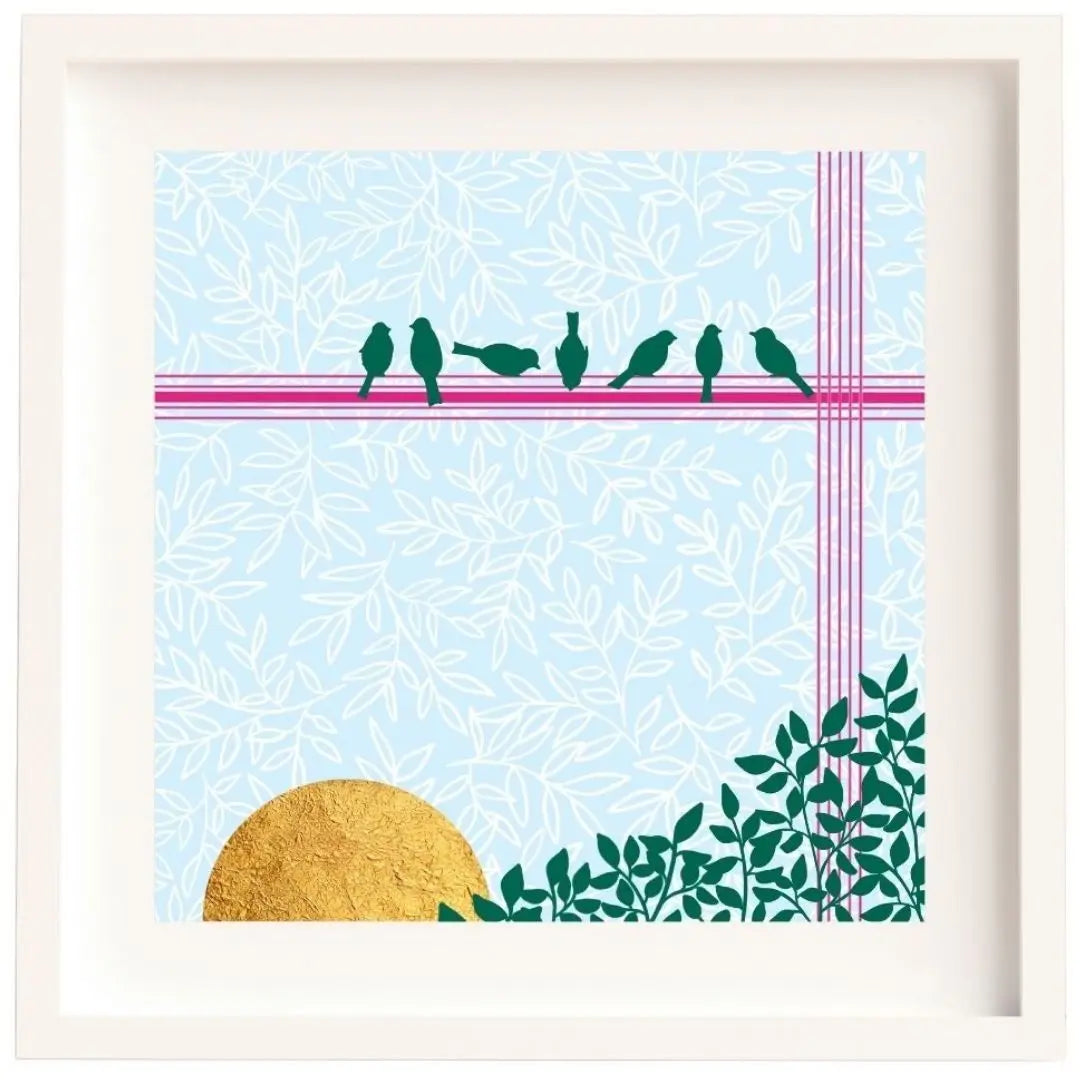 Framed artwork of 7 little birds sitting on a hot pink line across the top of the image. The background is pale blue with a delicate white leafy overlay. In the bottom left of the design is a gold sun. The sun is made from gold leaf. The illustration is mounted and framed in a white solid wood Irish made frame.