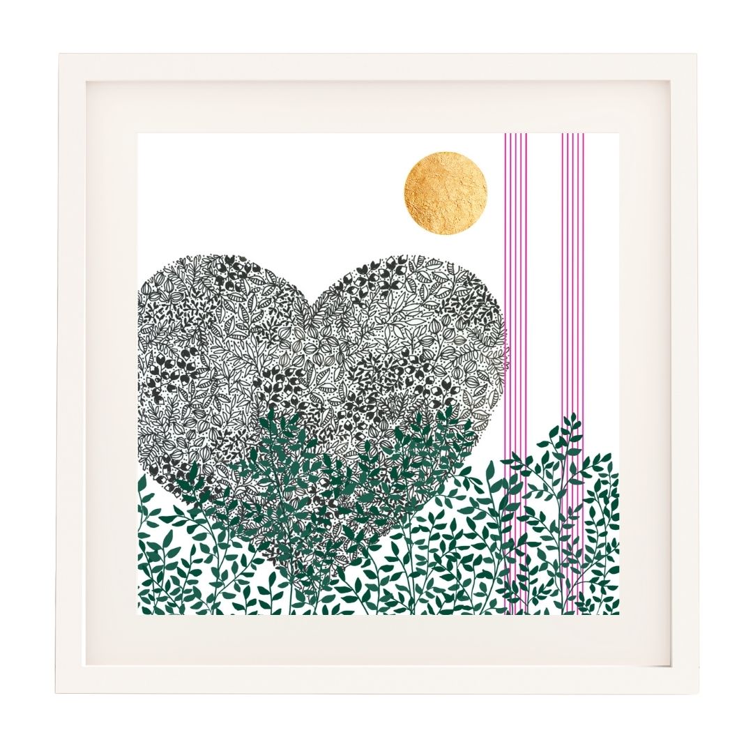 Image of a framed botanical art print featuring a black pen heart illustration. The heart is composed of detailed black leaf patterns, with green leafy foliage running along the base of the print. A gold leaf sun is positioned in the top right corner, alongside thin vertical bright pink lines. The artwork is set against a white background and framed in a clean, white wooden frame and a white mount.