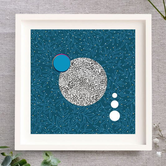Irish Print called Luna 1. Blue background with a botanical leaf overlay in a lighter blue. Centred in the design is a full moon, with leafy details in black pen. There are three white circles like satellites, and one blue circle representing Earth.