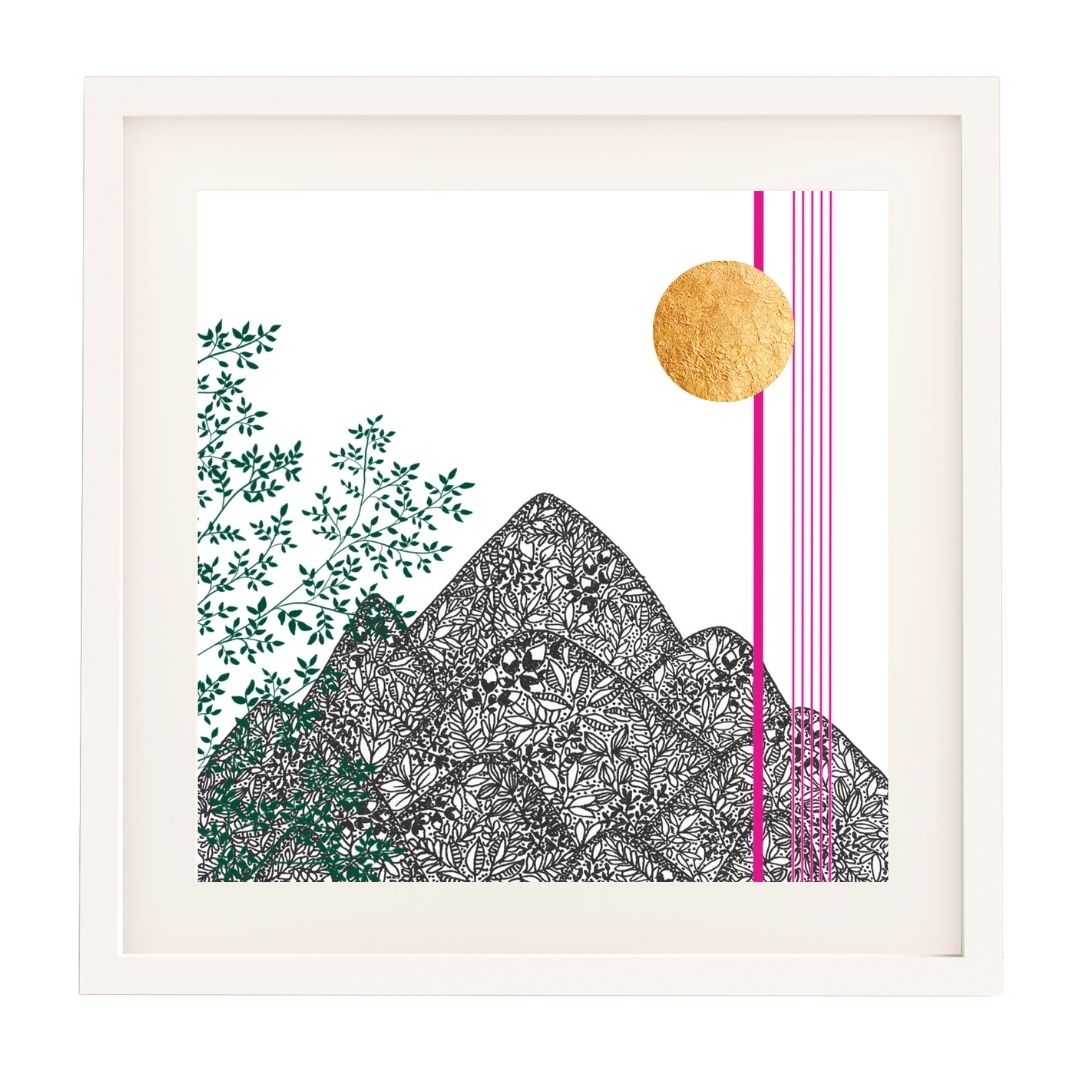 Framed art print featuring a botanical mountain landscape. The mountains are illustrated with intricate black leaf patterns, with green leafy branches on the left side. A gold leaf sun shines on the right, accompanied by thin vertical pink lines. The artwork is set against a white background and framed in a minimalist white frame.