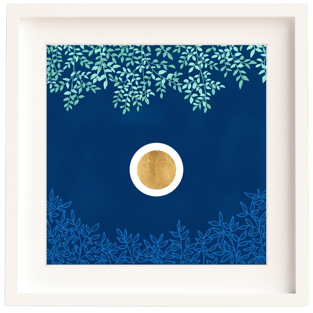 Framed Irish artwork of a gold leaf circle set in a white orb. These are set against a dark blue textured sky. Above there are green branches, and below there are light blue branches. The print is mounted and framed in a solid wood Irish made white frame.