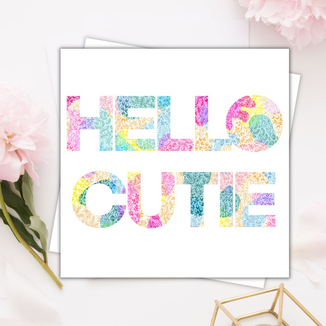 Image shows the phrase HELLO CUTIE illustrated on the fore front of the page. The drawing is multi coloured. 